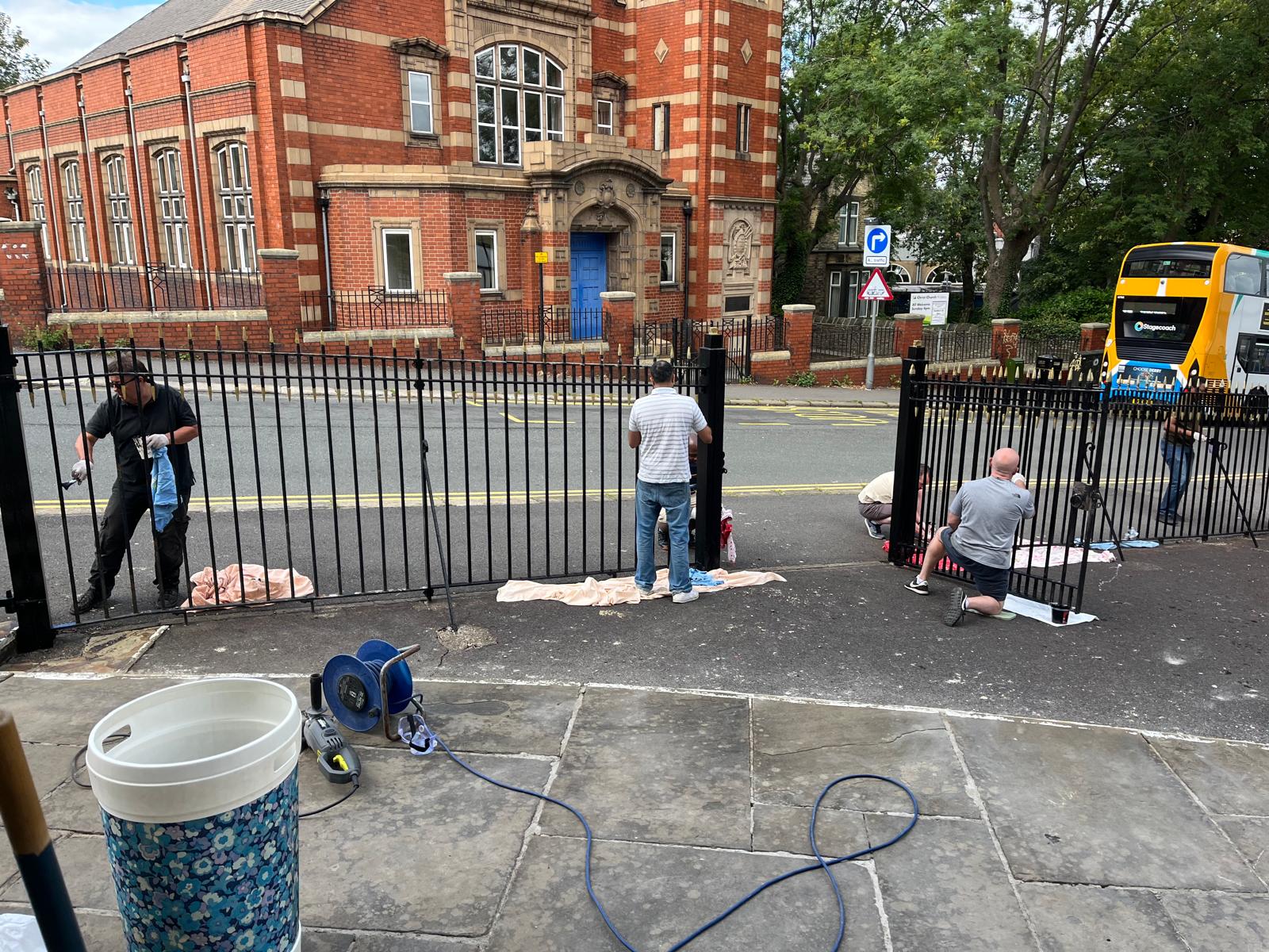 Volunteers repainting church railings